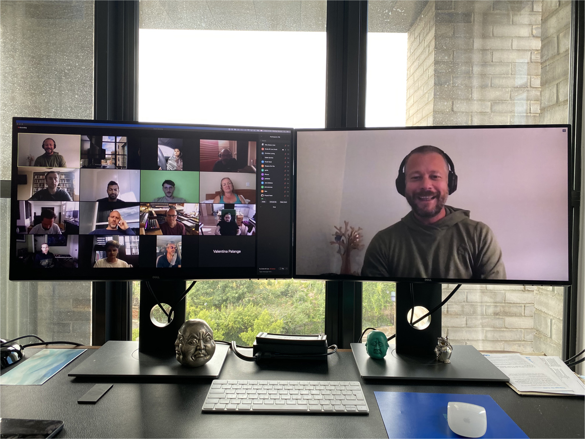 In Bloom workshop session on a dual-monitor desk — a video call with the Circle Of Live host and participants on screen