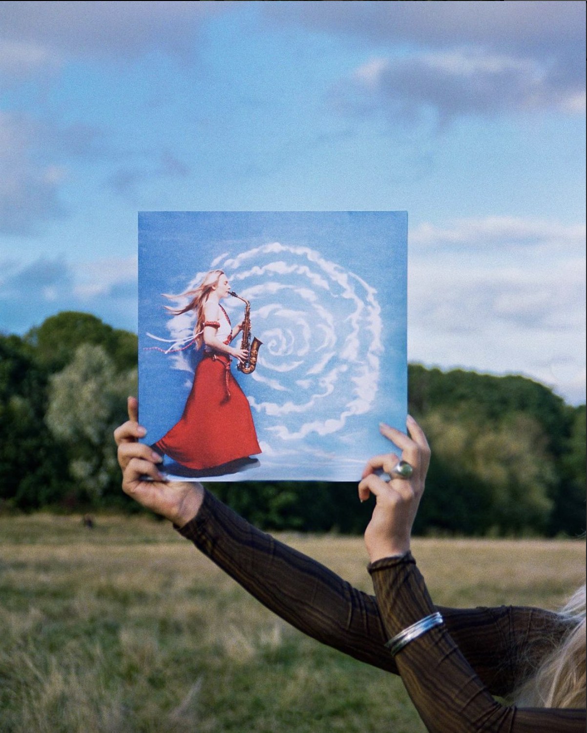 Laura Misch's album held up in a field